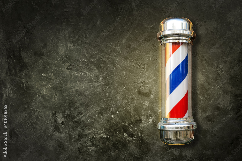 Barber pole. Barbershop pole on a textured background with copy space. - obrazy, fototapety, plakaty 