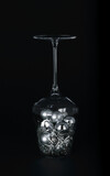 Fototapeta Paryż - Christmas silver toys in a glass goblet on a black background