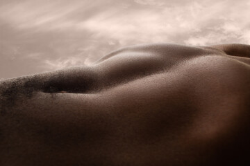 meadow. detailed texture of human skin. close up of young african-american male body surface like la