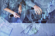© peshkova - Multi exposure of man and woman working together and forex graph hologram drawing. Financial analysis concept. Computer background. Top View.