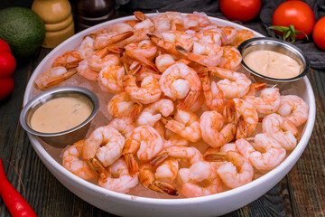 Canvas Print - boiled shrimp on ice on dark blue table