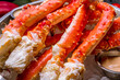 © bbivirys - King crab claws on wooden table