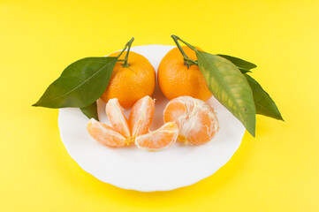 Fresh oranges bowl on yellow background