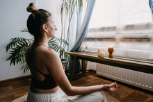 Self-care, Self-compassion, Mental Wellbeing In Post-pandemic World. Mental Health, Wellbeing, Meditation To Eliminate Anxiety. Young Woman Sitting On Floor Do Yoga Exercise And Meditation At Home