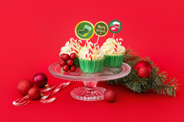 Wall Mural - Dessert stand with tasty Christmas cupcakes on color background