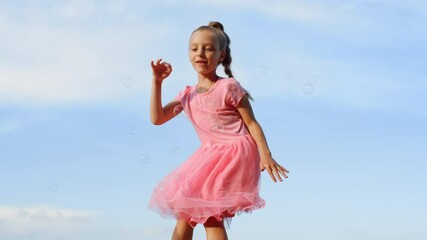 cheerful woman blowing soap bubbles in city park. joyful girl playing outdoor.