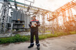 © Andrii - The energy engineer inspects the equipment of the substation. Power engineering. Industry