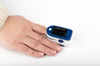 © svdolgov - Pulse oximeter on a finger over a light background. Close up. Copy space.