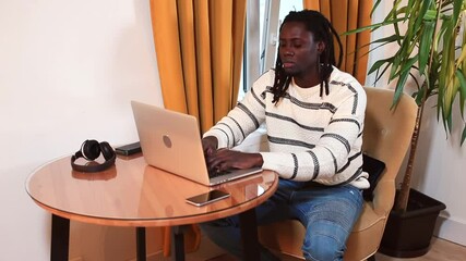 Poster - A man sitting at a table does work using a laptop. Digital data processing freelance project. Drinking water, raising the balance of body fluids, increasing working capacity.