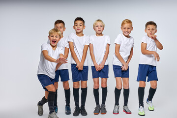 Wall Mural - team of soccer players ready to take the ball, stood in a row, closing lower part of body, isolated portrait