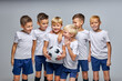 © Roman - children soccer team isolated in studio, friendly kids sport family leisure lifestyle concept. copy space advertisement