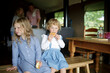 © Sam Edwards/Caia Image - Portrait cute sisters eating biscuits on kitchen bench