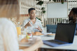 © Paul Bradbury/Caia Image - Businesswoman talking with coworkers in office meeting