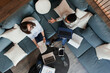 © Paul Bradbury/Caia Image - Businesswomen with laptops and paperwork meeting on office sofa