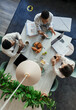 © Paul Bradbury/Caia Image - Business people talking over breakfast in office meeting