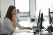© Paul Bradbury/Caia Image - Businesswoman in headset working at computer in call center office
