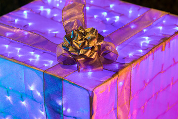 iluminated gift box with bright colors and ribbon