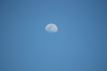 White Waning Moon In A Blue Sky