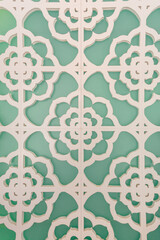 Aqua wall with a white abstract floral patterned overlay