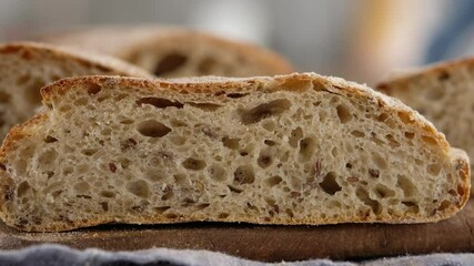 Wall Mural - Female hand clicks on bread and it returns to its original state. Sliced bread lies on a wooden board. Cooking the ciabatta. Italian bread. Rye bread. 4K