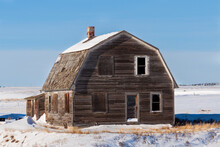 Abandoned Homestead Sitting Alone In A Field On A Cold Winters Day In Rural Alberta