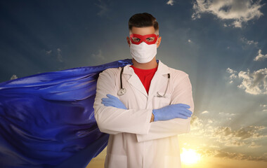 Canvas Print - Medical workers fighting with dangerous diseases. Doctor dressed as superhero posing against sky