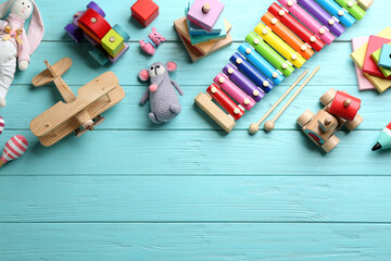 Wall Mural - Different toys on light blue wooden background, flat lay. Space for text