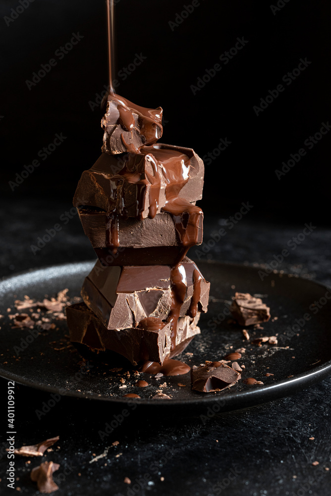 Stack of chocolate cubes on black background Stock Photo | Adobe Stock
