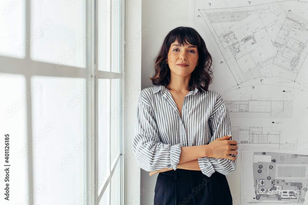 Confident female architect standing in office - obrazy, fototapety, plakaty 