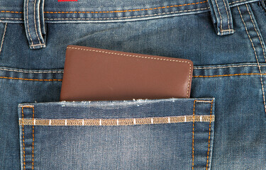 Wallet in the pocket of jeans pants