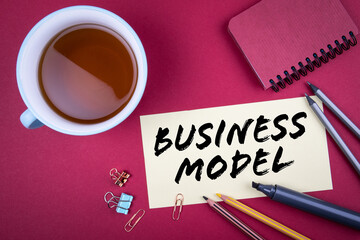 Wall Mural - Business model. Teacup and stationery on a red table