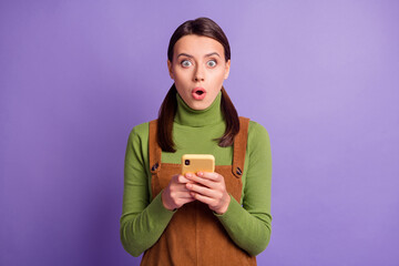 Sticker - Portrait of lovely amazed girl using device browsing post media pout lips isolated over vibrant violet color background