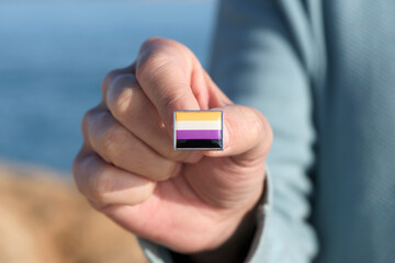 Canvas Print - person showing a non-binary pride flag