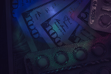 Poster - Pills or drugs and dollars cash money in a package under neon light on a dark background pattern for design..