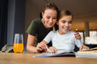 © Drobot Dean - Beautiful happy military woman doing homework with her daughter at home