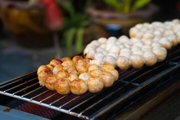 Wall Mural - Meatballs are fried on an open-air stove at a street food market in Asia