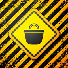 Wall Mural - Black Beach bag icon isolated on yellow background. Warning sign. Vector.