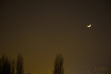 Bursa Sky During Foggy Night. Crescent Moon And Trees. Lights Observed From Ulu Mountain (uluda) Mountain Foot.