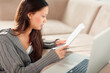 © momentimages/Tetra Images - Woman reading paperwork