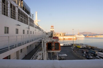 evocative image of lifeboats on the side of a ferry