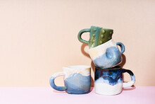 Still Life Of Handmade Ceramic Mugs On Bright Studio Background