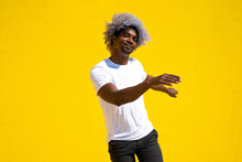 Afro Black Man Dancer Dancing On A Yellow Background. Dance And Music Concept. Black Man Dancing.