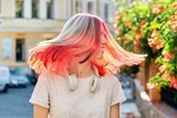 Close-up of fluttering colored dyed hair of young woman on sunny city street