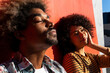 © David Munoz/ADDICTIVE STOCK - Stylish African American male with Afro hairstyle standing with eyes closed near happy female friend on street