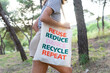 © David Munoz/ADDICTIVE STOCK - Side view of unrecognizable female walking in woods with reusable eco friendly bag while showing zero waste concept