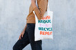 © David Munoz/ADDICTIVE STOCK - Side view of cropped unrecognizable stylish young ethnic lady in casual clothes carrying eco friendly cotton bag while standing on street