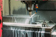 © Harry Rendon/ADDICTIVE STOCK - Foamy cutting fluids spraying on spinning metalworking equipment in light modern industrial workshop