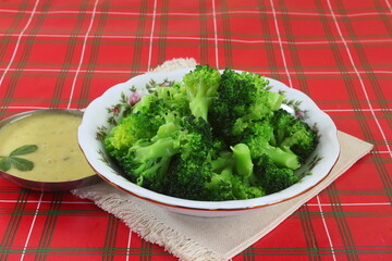Wall Mural - green boiled or steamed broccoli vegetable with ranch or sauce for salad or cooking