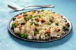 © Katerina Solovyeva/ADDICTIVE STOCK - Vegan rice with vegetables, healthy and delicious, on a blue background