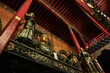 From below of aged oriental palace with national monuments on metal balcony located among ornamental roof